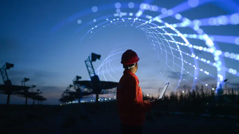 Technician in field with antennas
